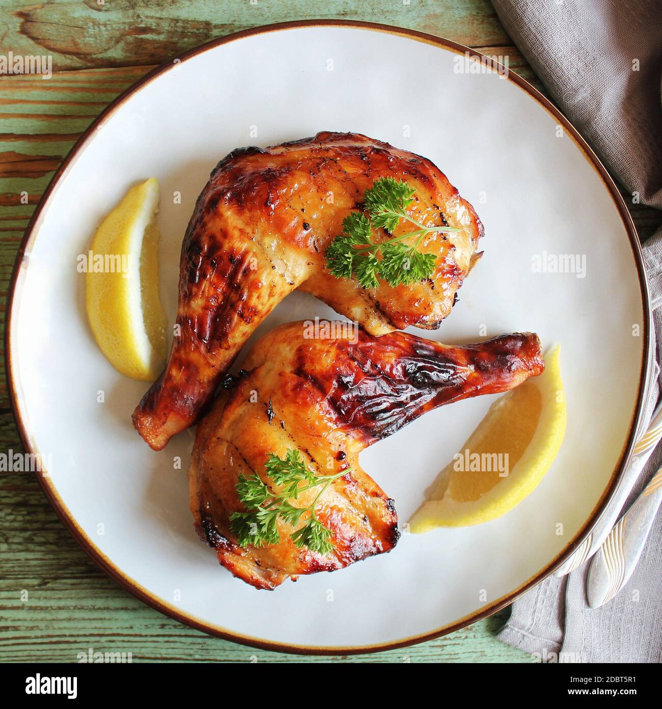 Food background. Grilled chicken leg quarters with crispy golden brown