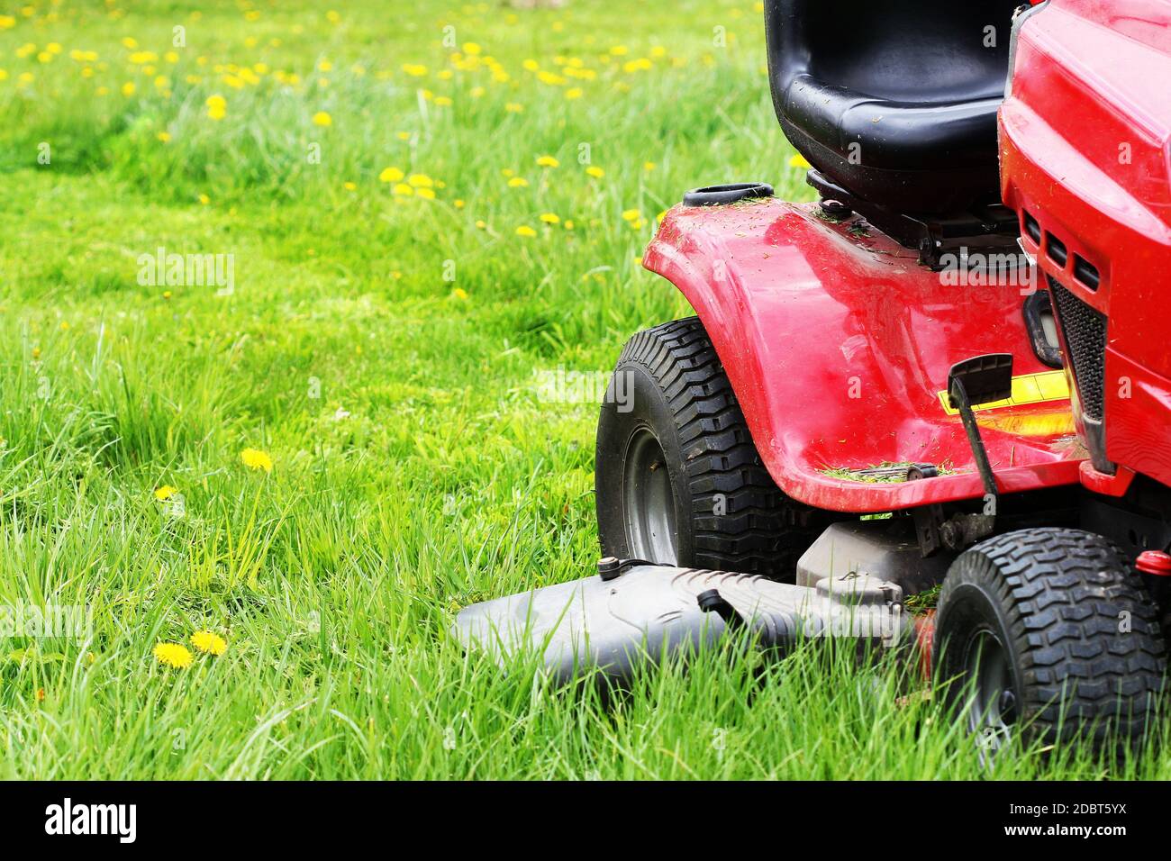 Cutting grass with a riding lawn mower hotsell