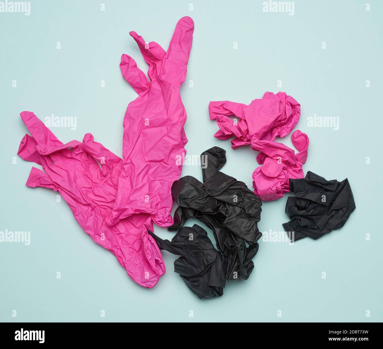 black and pink latex gloves on a blue background, recyclable trash, top