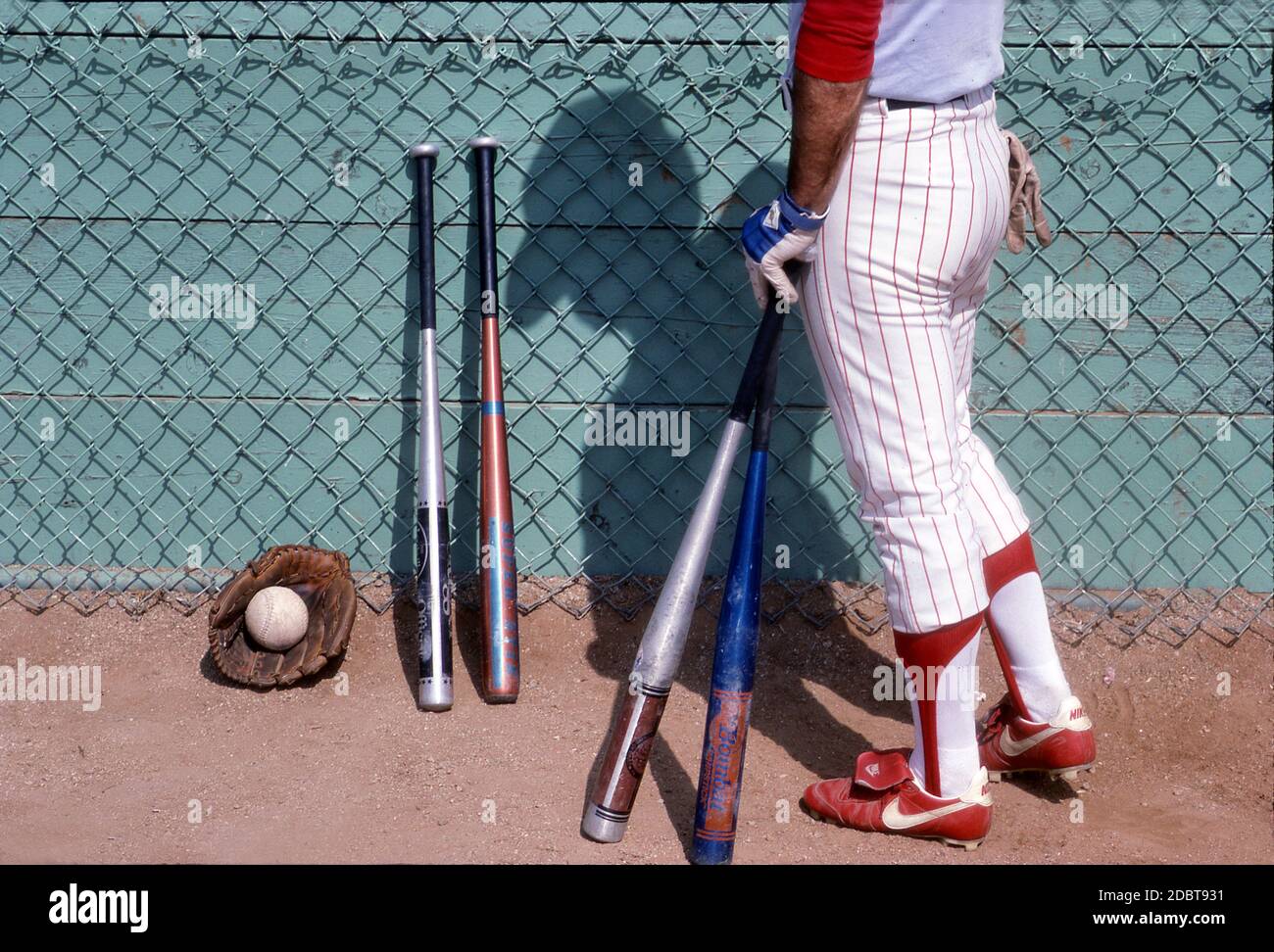 Softball player with sporting equipment for batting and fielding Stock Photo