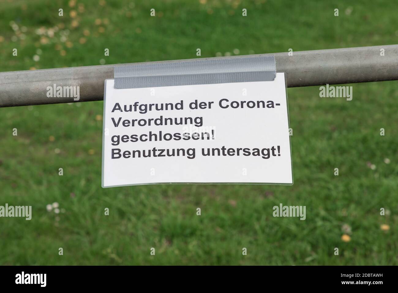 Covid-19 safety prevention. Closure prohibition sign. German text mean closed because of coronavirus restriction regulation! Keep off! Stock Photo
