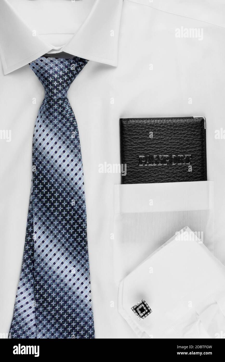 Passport lying on the shirt and tie, can be used as background Stock