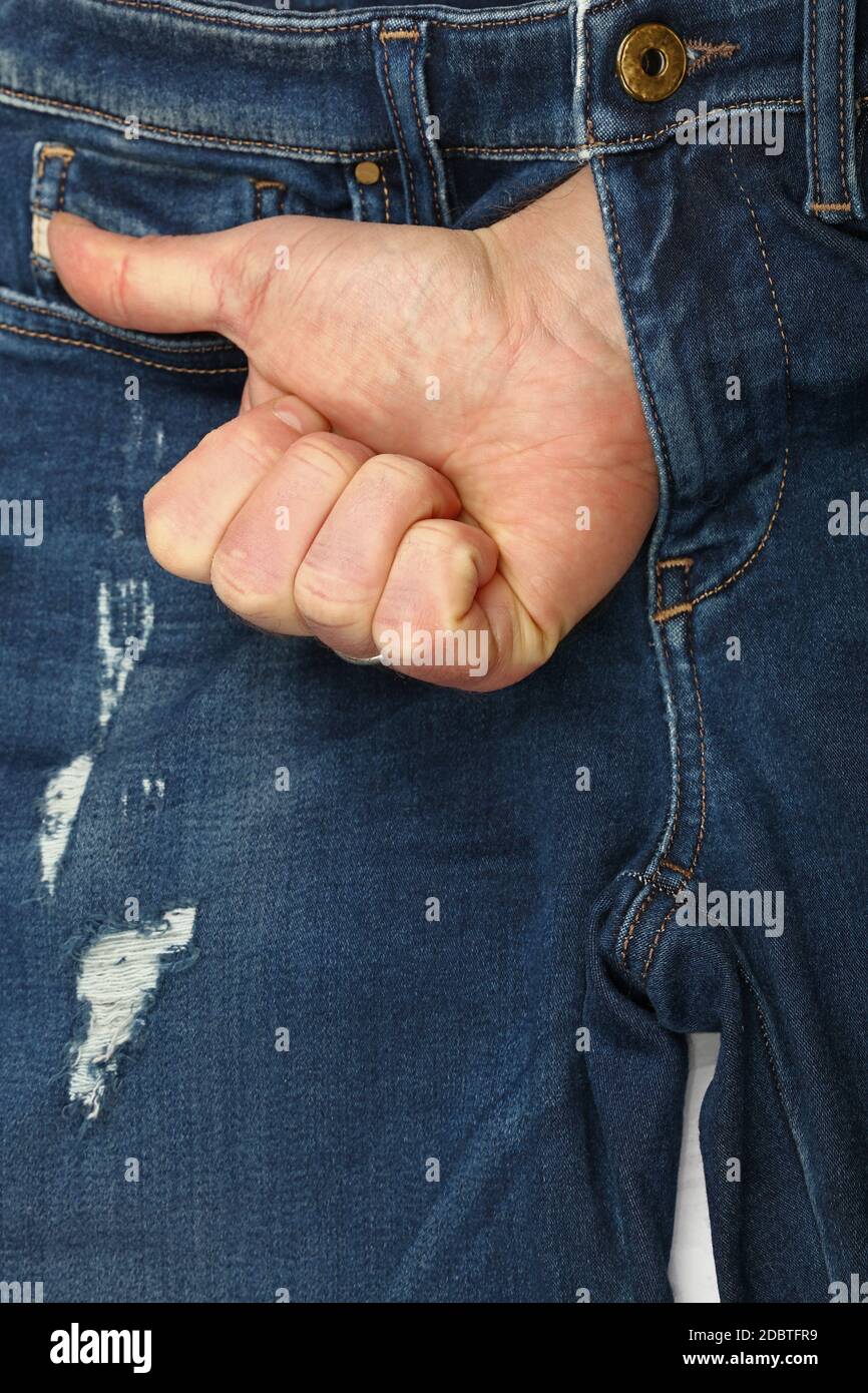 Close up man hand shows thumb up or like gesture out of open jeans