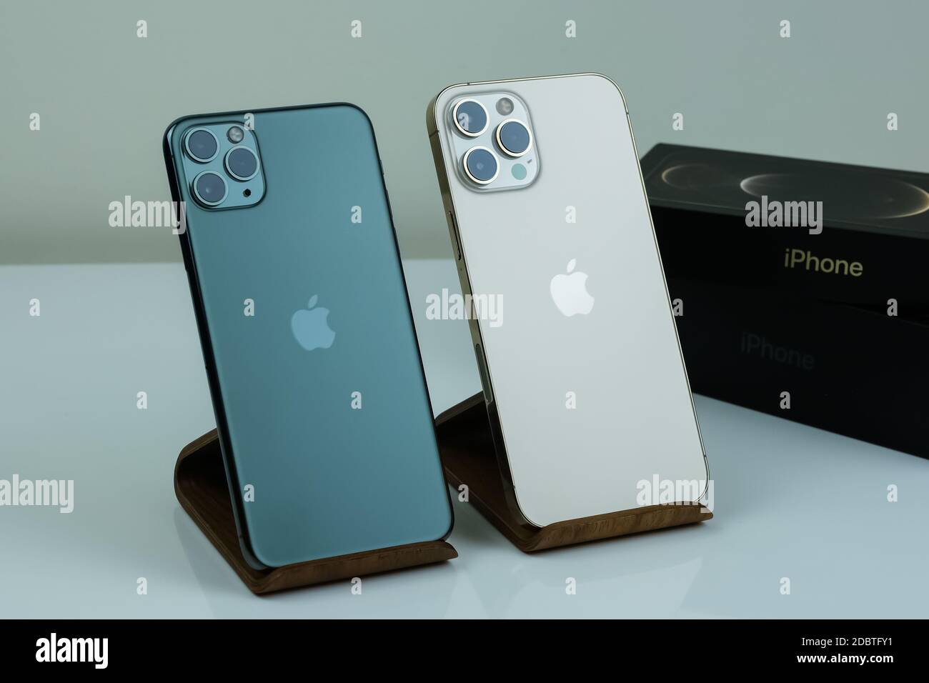 Iphone 12 Pro Max In Gold Next To Iphone 11 Pro Max In Midnight Green Color Stock Photo Alamy