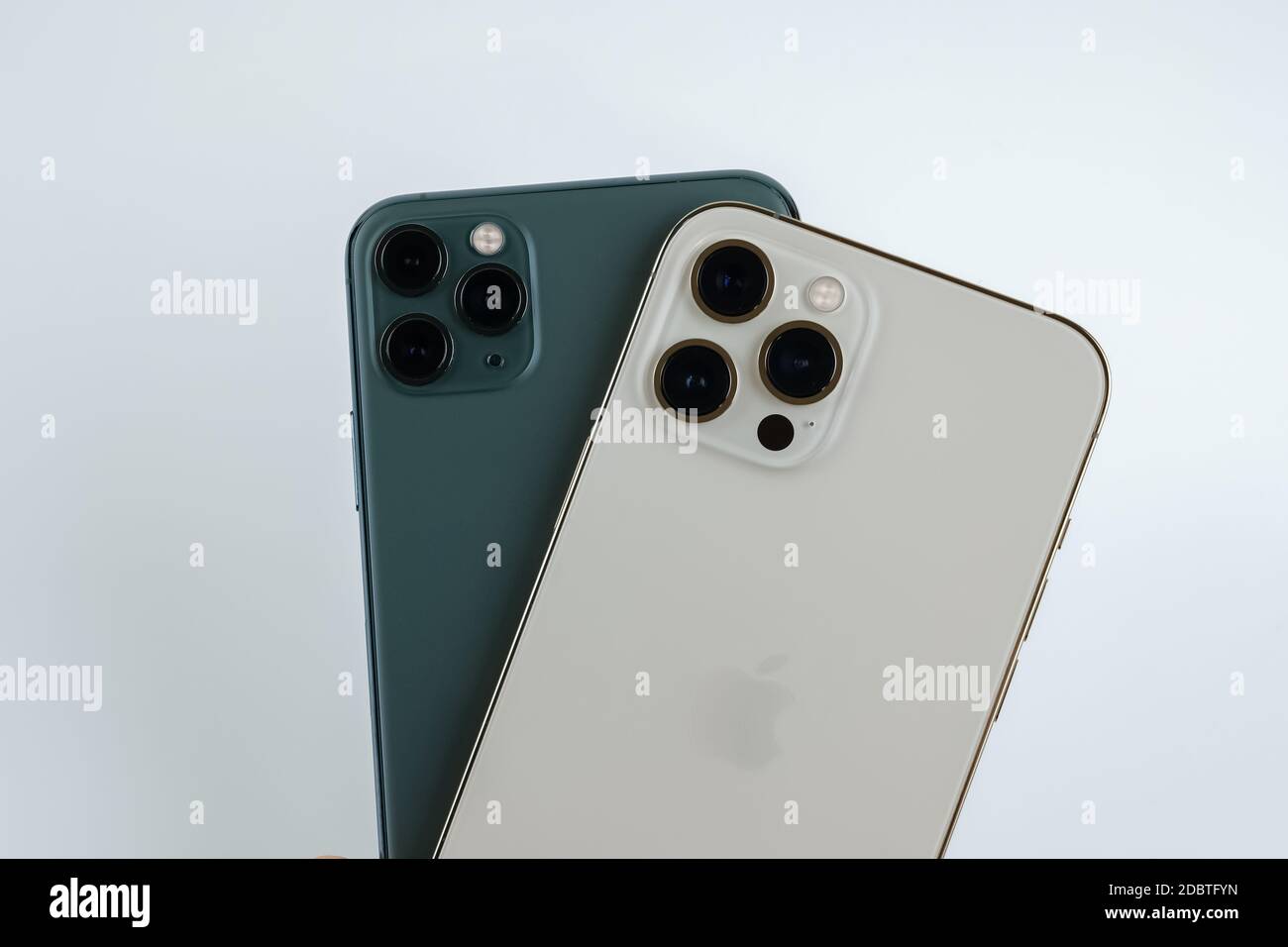 Iphone 12 Pro Max In Gold Next To Iphone 11 Pro Max In Midnight Green Color Stock Photo Alamy