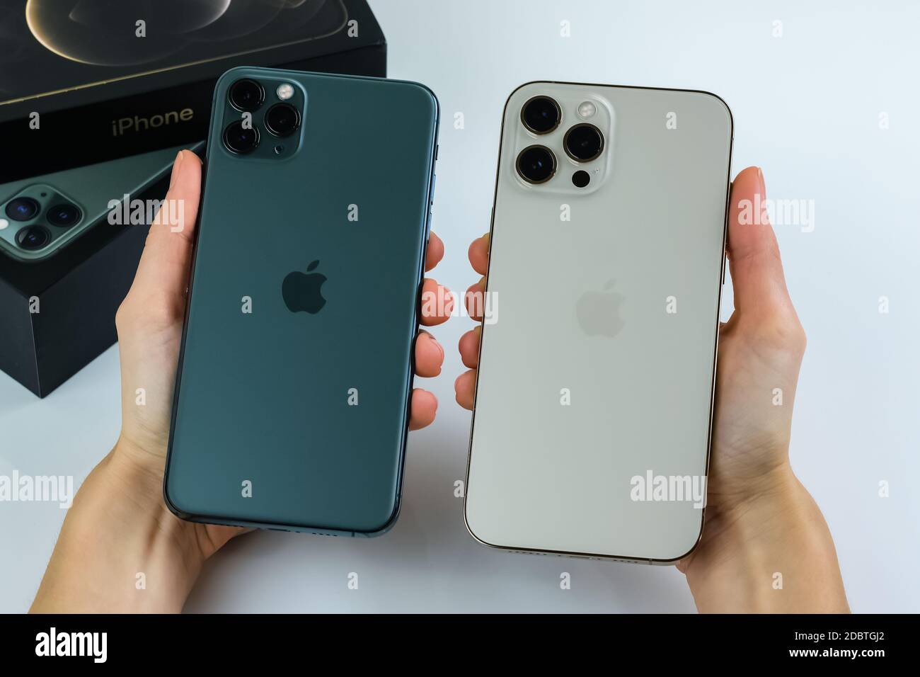Iphone 12 Pro Max In Gold Next To Iphone 11 Pro Max In Midnight Green Color Stock Photo Alamy