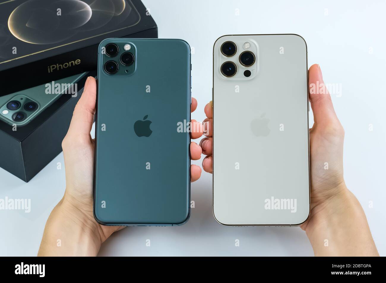 Iphone 12 Pro Max In Gold Next To Iphone 11 Pro Max In Midnight Green Color Stock Photo Alamy