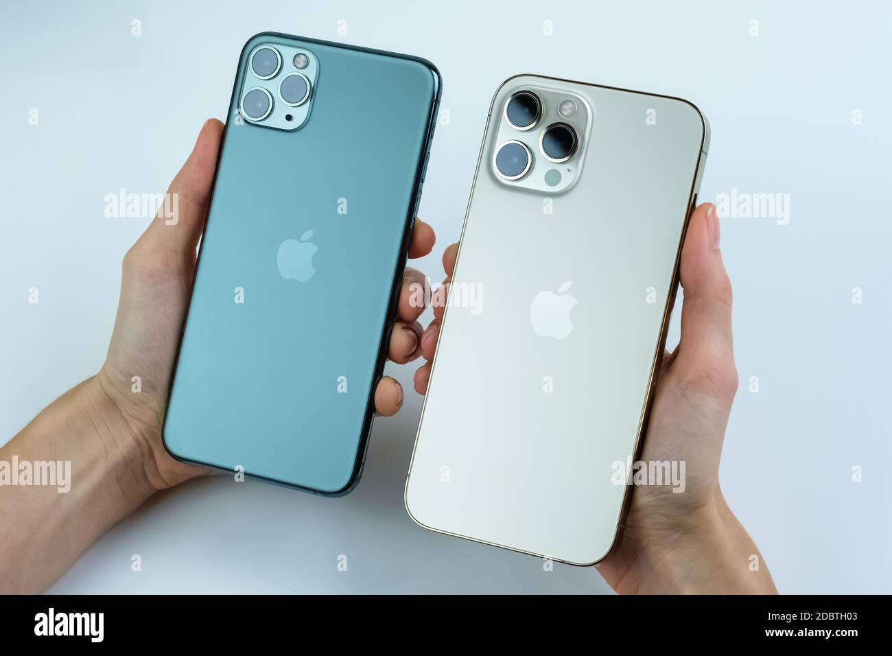 Iphone 12 Pro Max In Gold Next To Iphone 11 Pro Max In Midnight Green Color Stock Photo Alamy