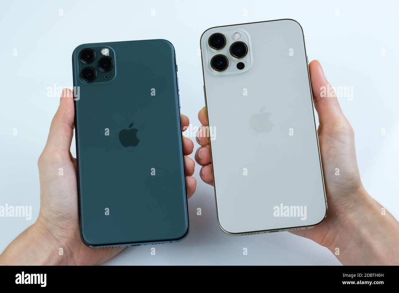 iPhone 12 Pro Max in Gold next to iPhone 11 Pro Max in Midnight