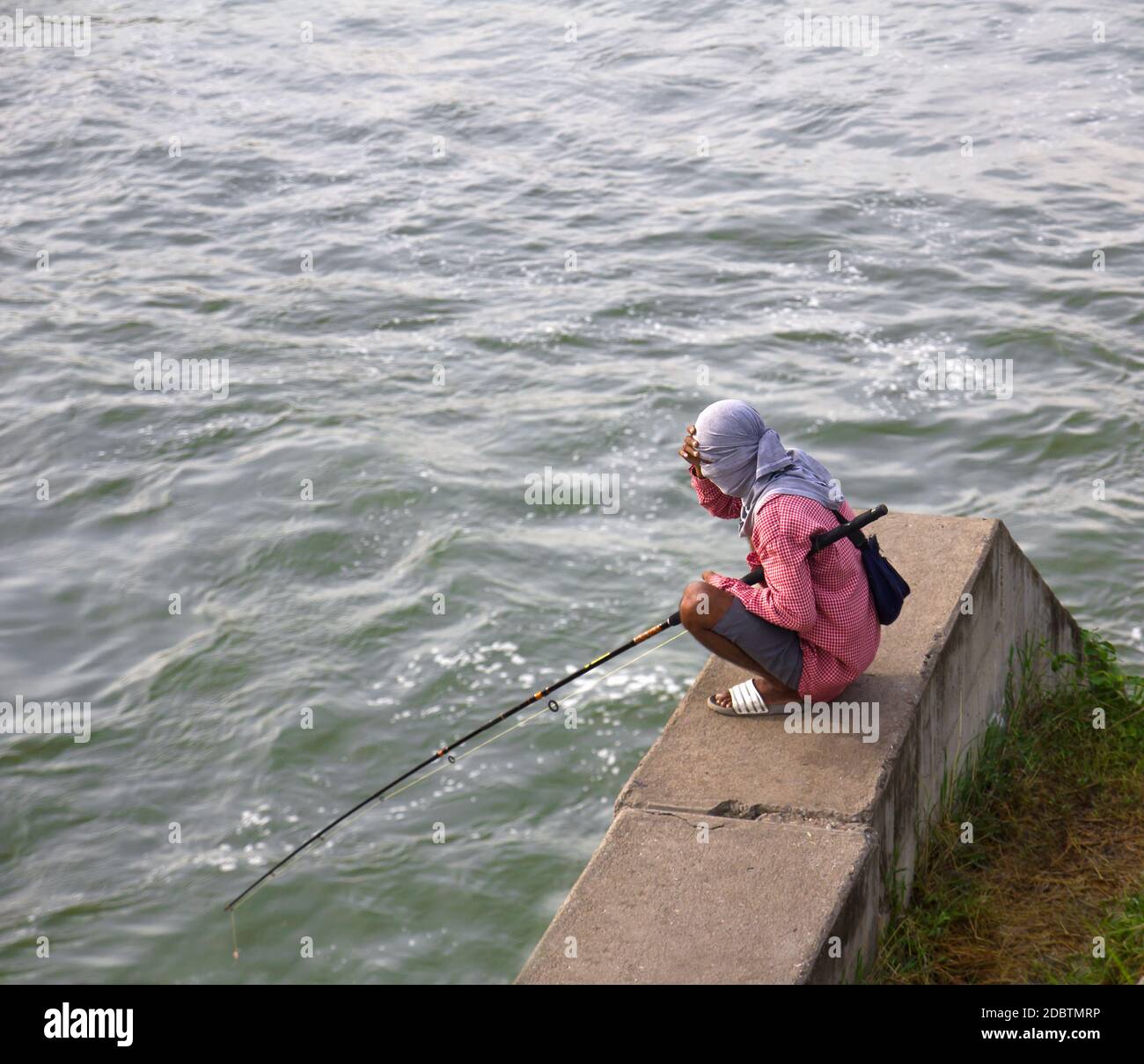 Fishermen waiting to catch a fish hook Stock Photo - Alamy