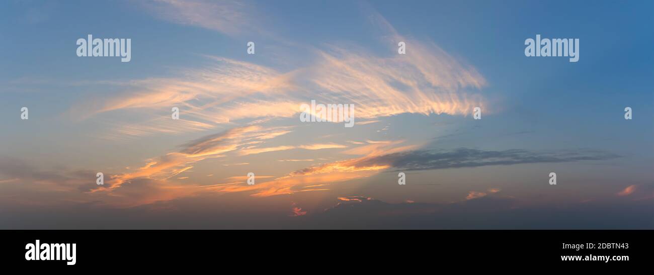 Panoramic blue sky fluffy clouds in the twighligth sky Stock Photo - Alamy