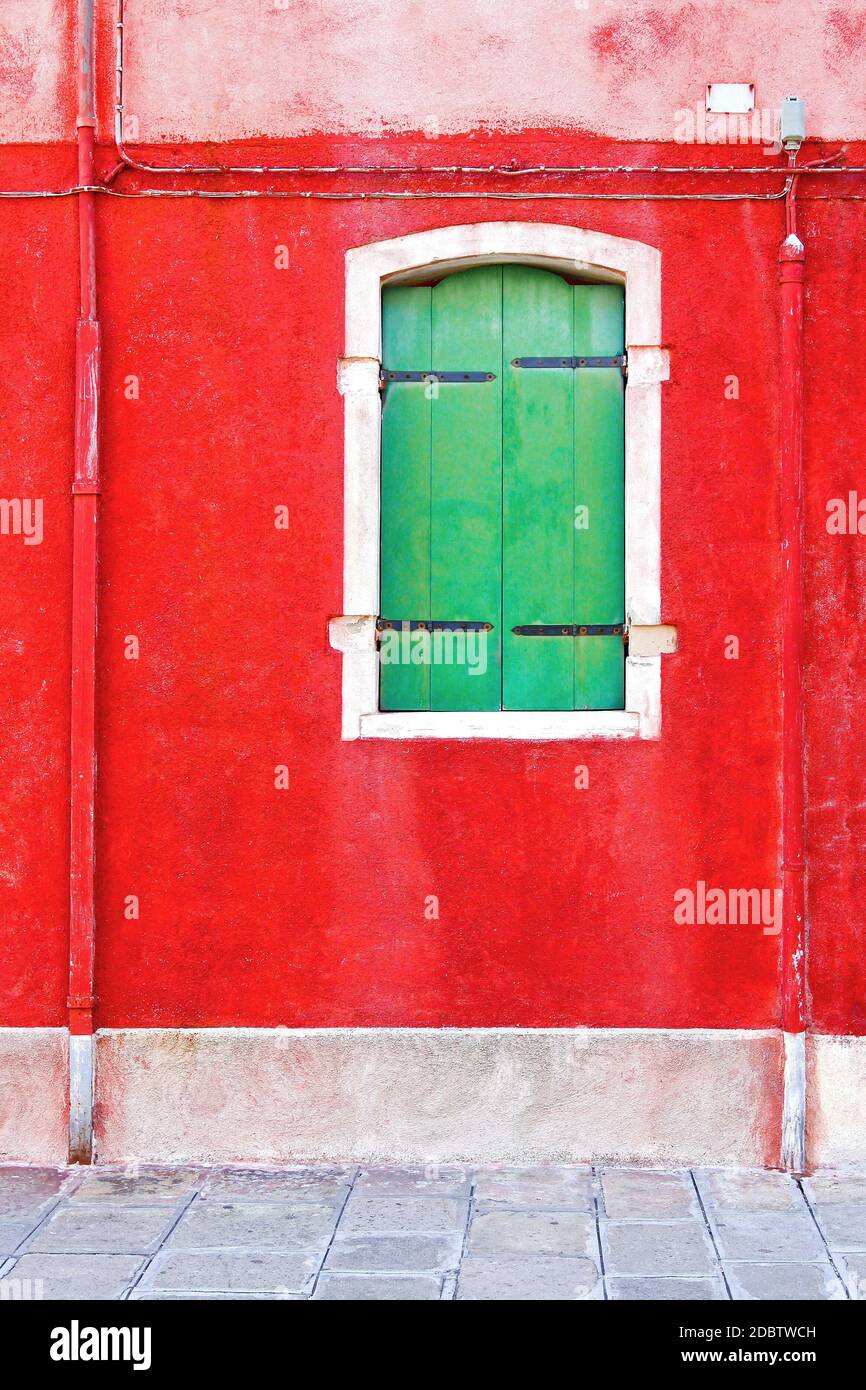 Closed green wooden window with red wall Stock Photo - Alamy