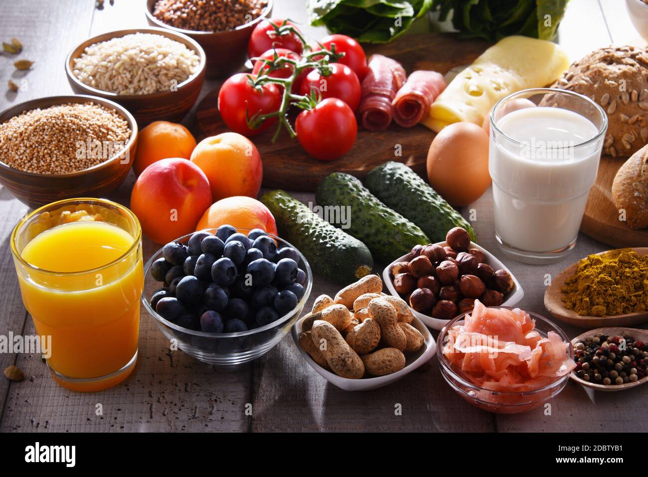 Composition with assorted organic food products on wooden kitchen table ...