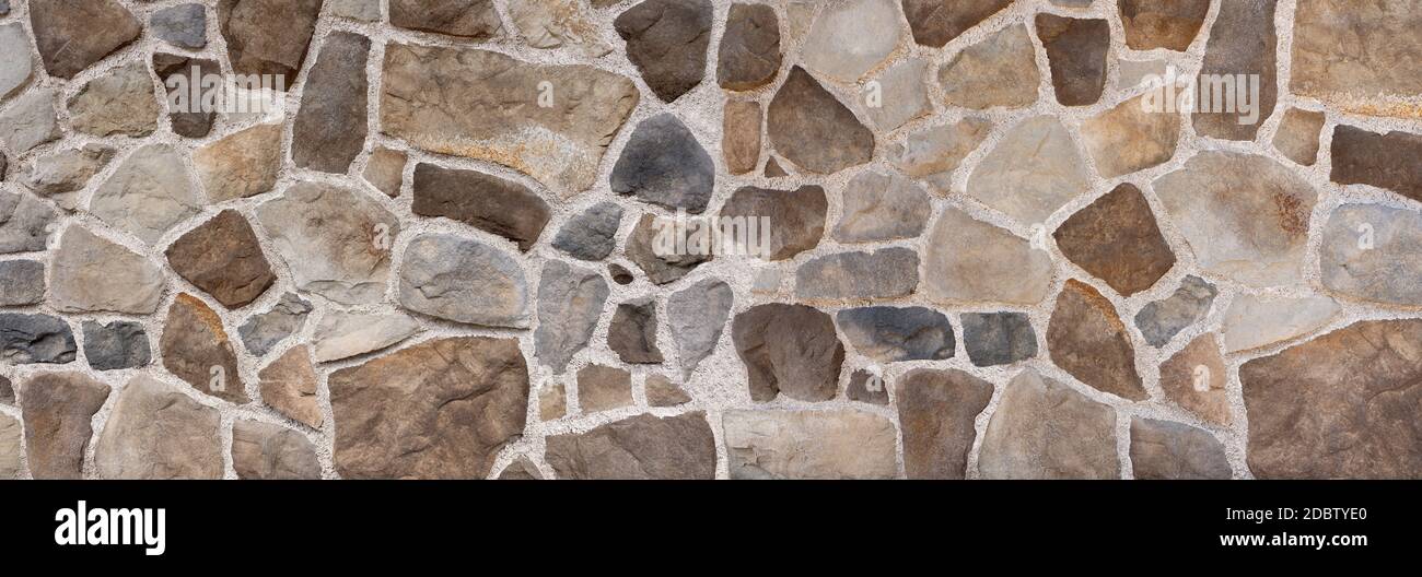Wall made of brown and gray natural stones Stock Photo - Alamy
