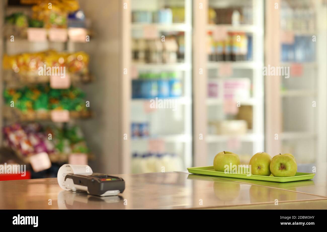 A school canteen tuck-shop or cafe serving healthy fruit food options. Chips and drinks on display in the background. Electronic payment terminal Stock Photo