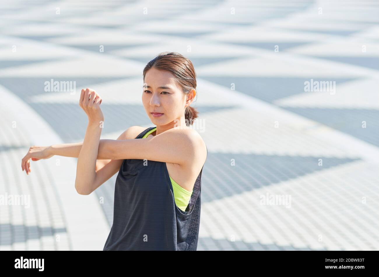 Young Japanese Woman Stretching Downtown Tokyo, Japan Stock Photo - Alamy