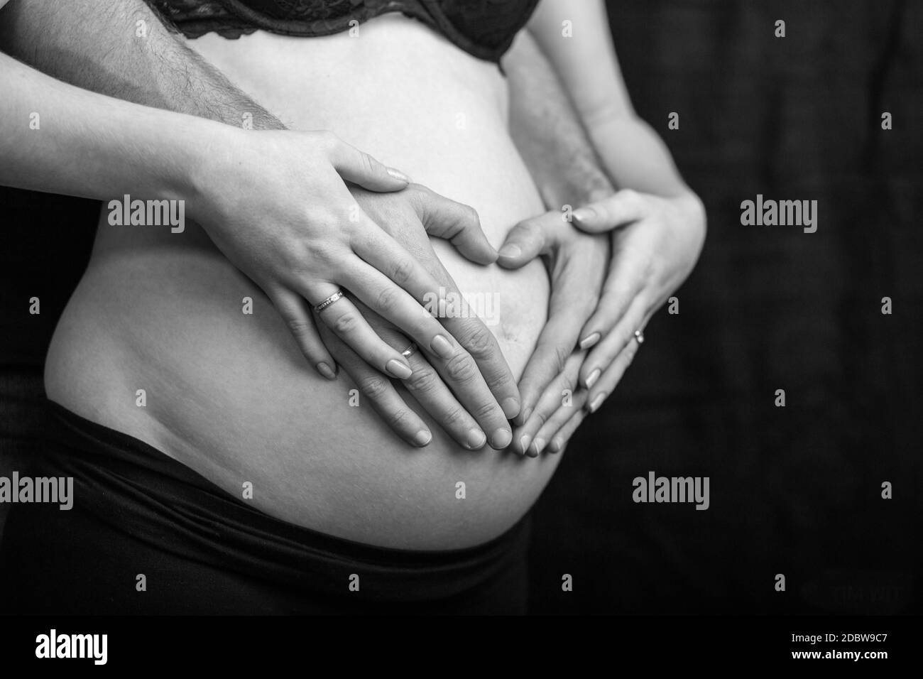 pregnant couple in love with baby belly. Hands on stomach baby bump. husband hand pregnant belly Stock Photo