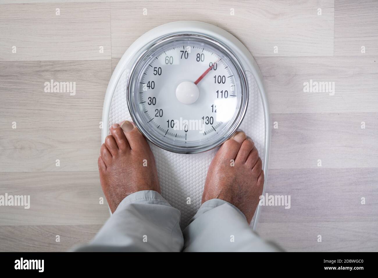 Man Feet On Weight Scale. Obesity And High Cholesterol Stock Photo Alamy