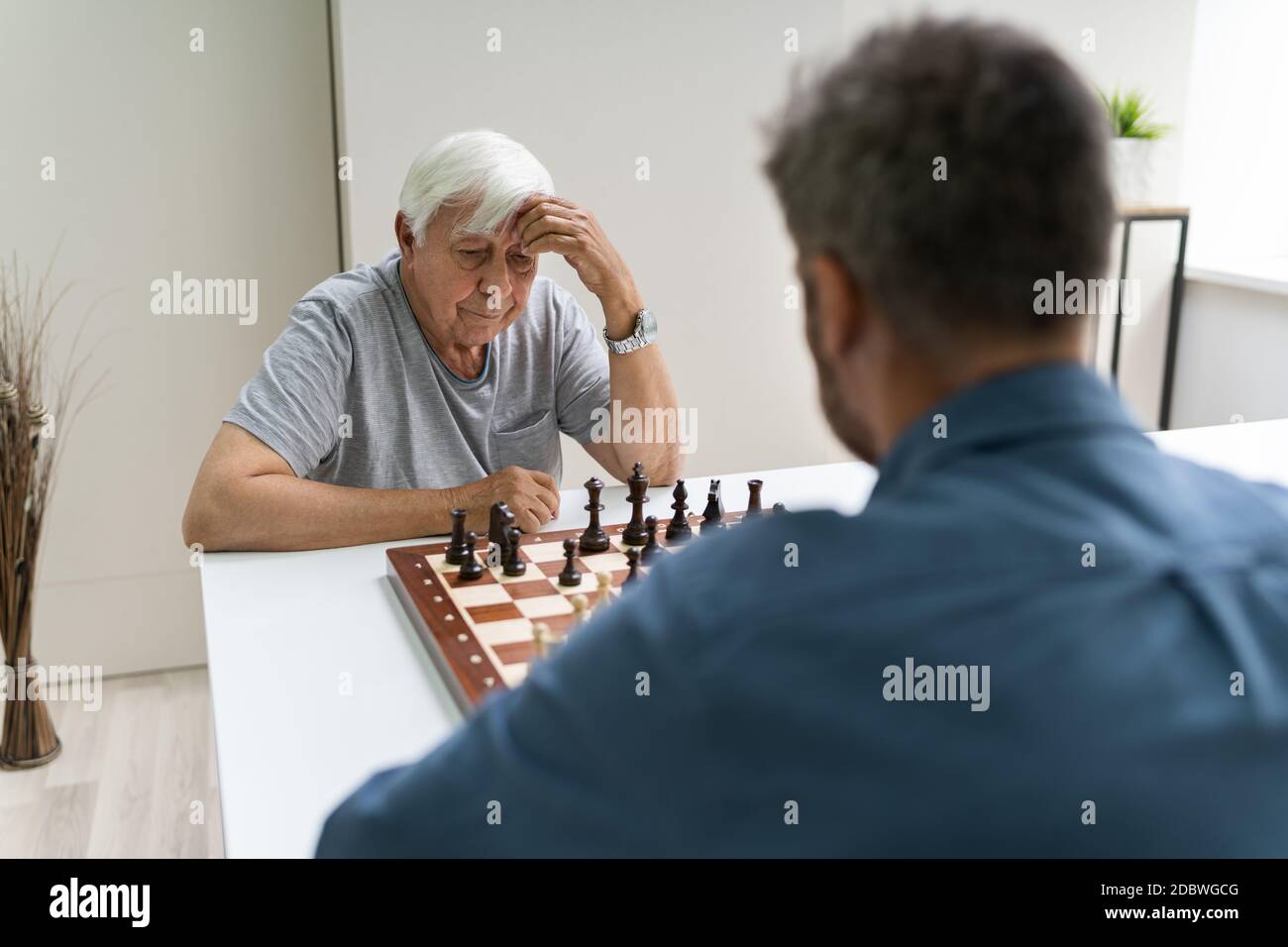 Elderly Senior Playing Chess Table Board Game Stock Photo