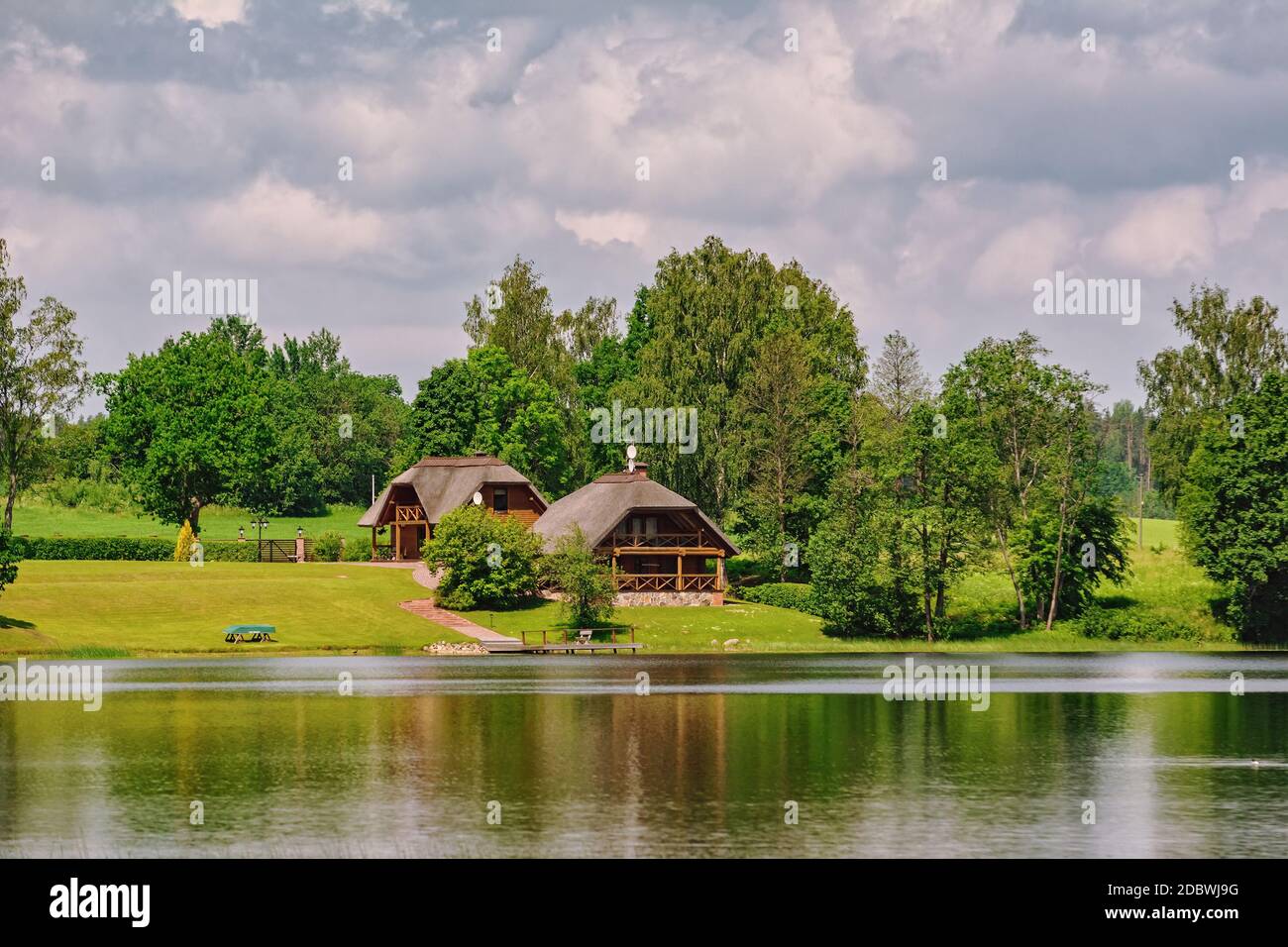 Two houses on the bank of the river Stock Photo - Alamy