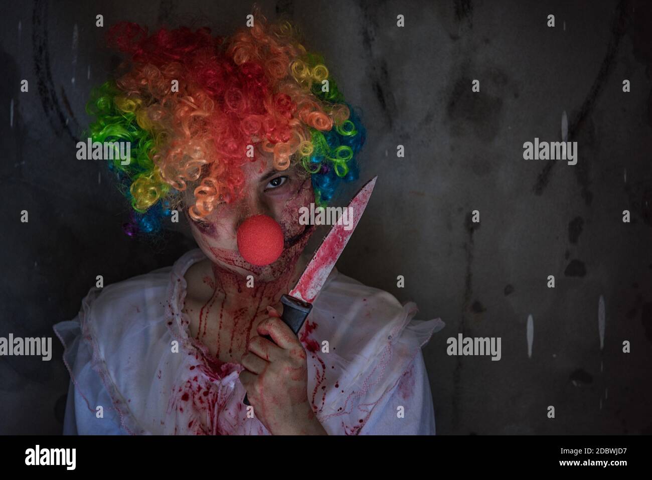 Asia joker ghost girl or Zombie holding knife, Halloween concept Stock Photo
