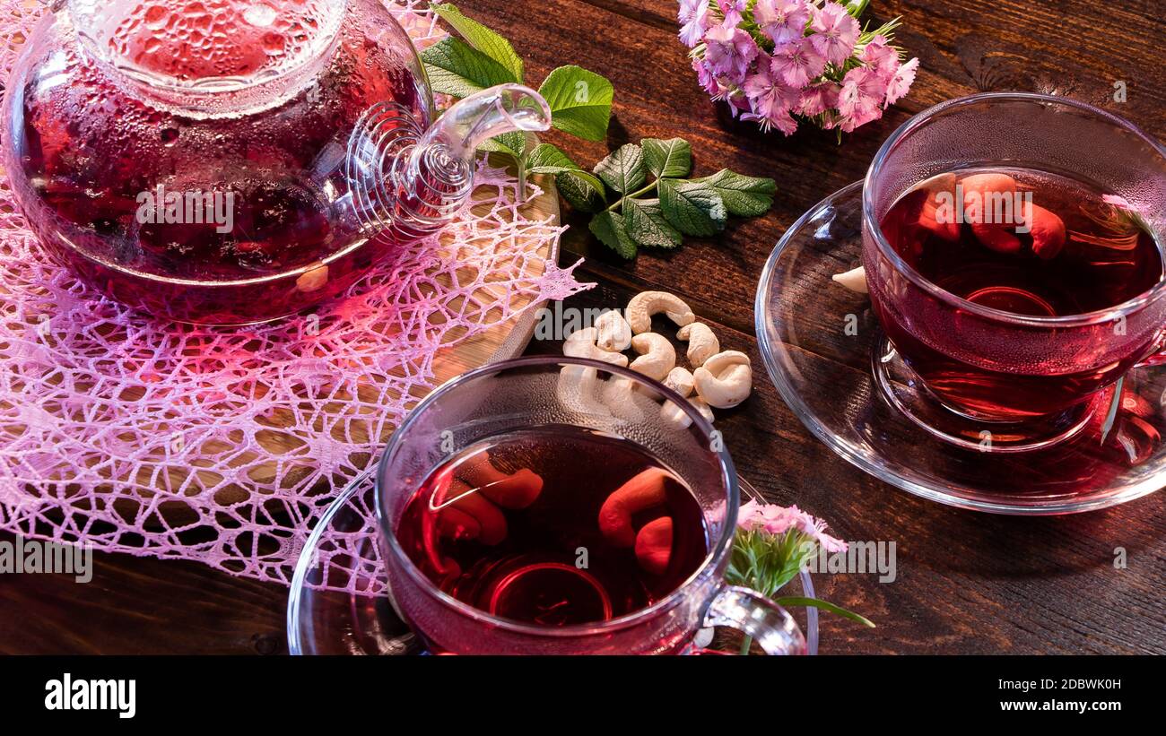 Green tea leaves or leaves of medicinal herbs lie on the table with a