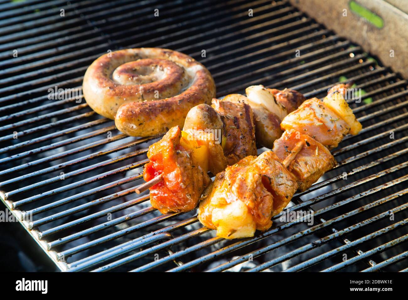 Grilled meat on a summer barbecue in the garden Stock Photo - Alamy