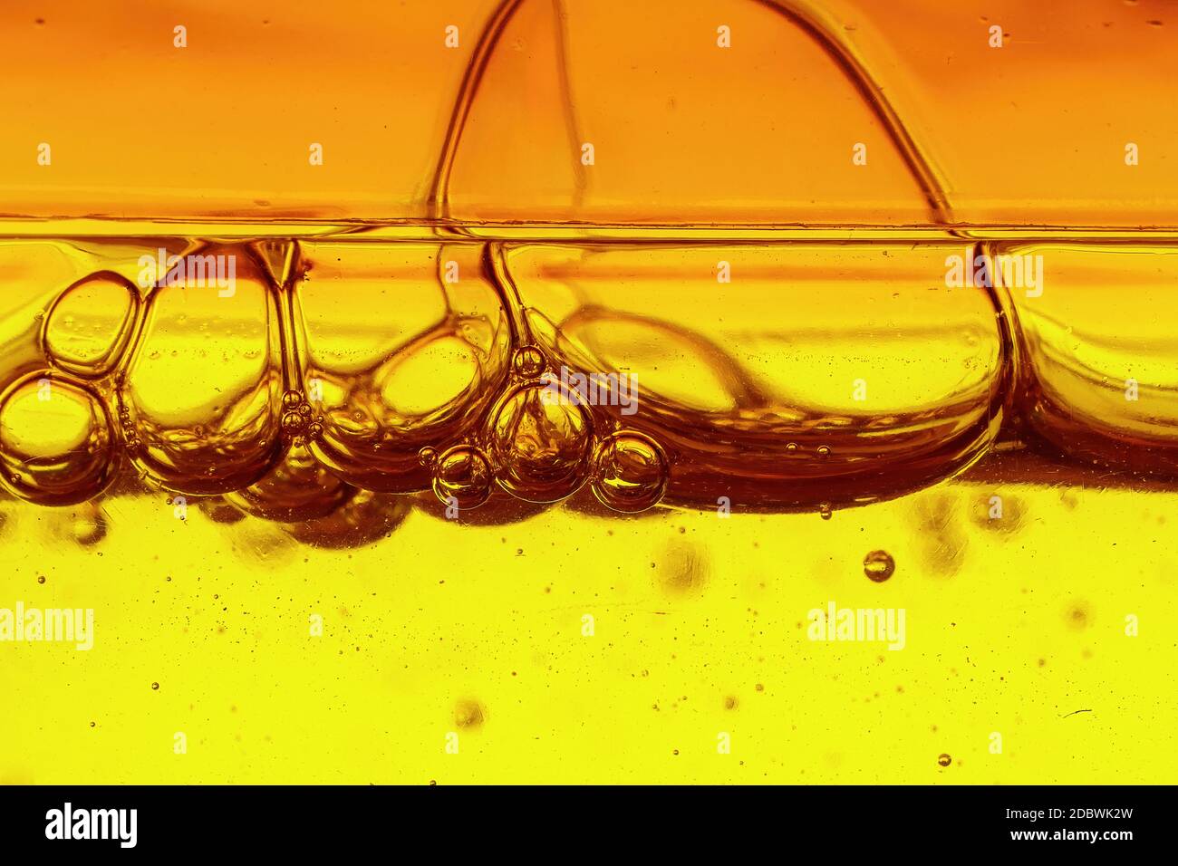 A viscous yellow liquid with air bubbles, macro shot Stock Photo