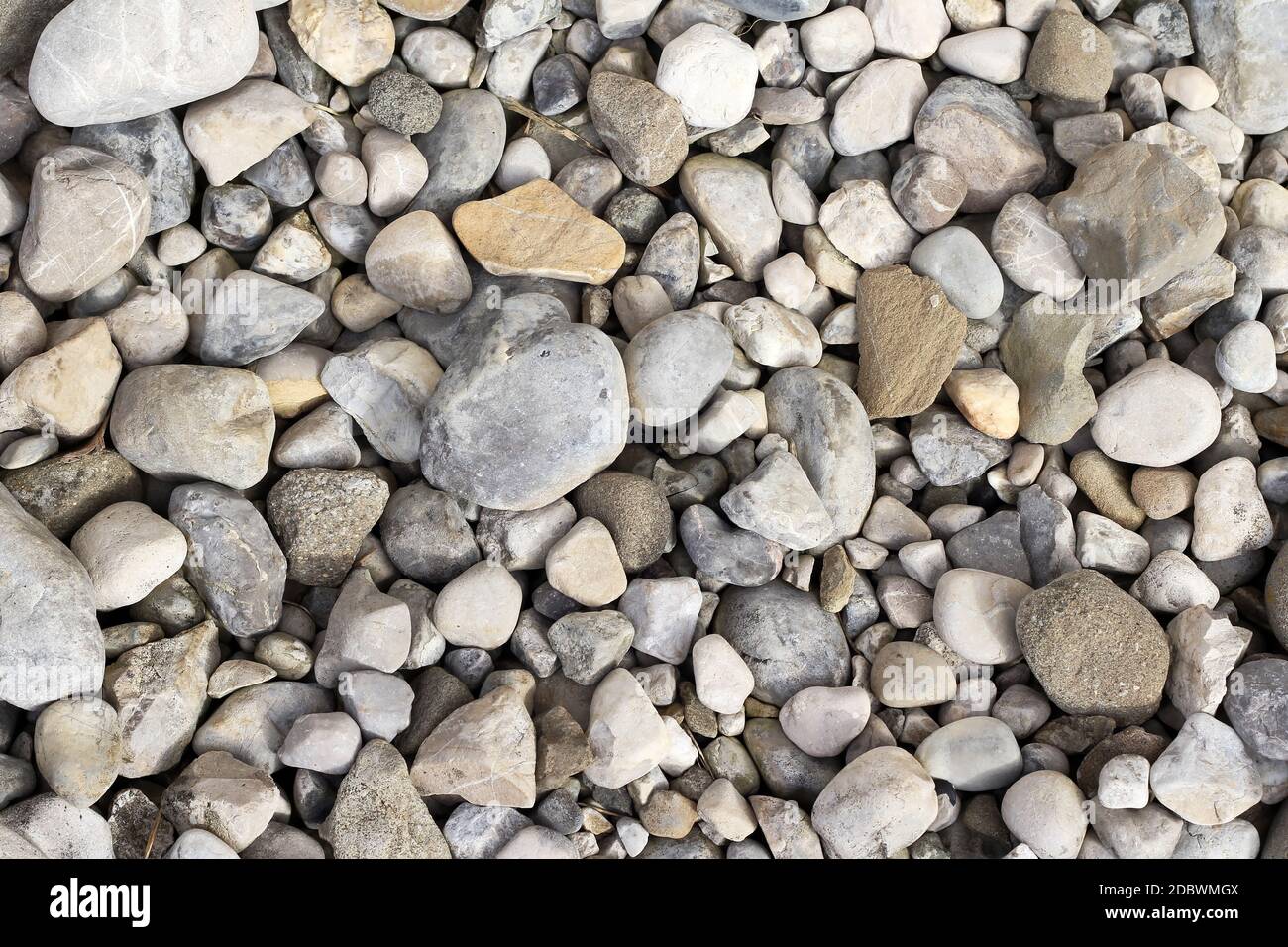 Background image with grey and beige stones and pebbles on the floor Stock Photo
