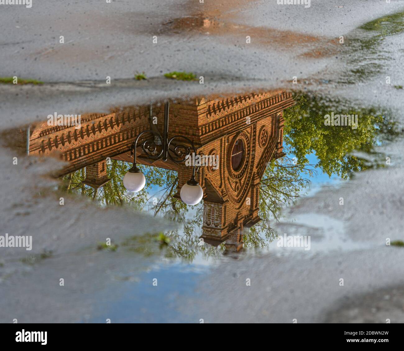reflection of city buildings and street lights in puddles after rain ...