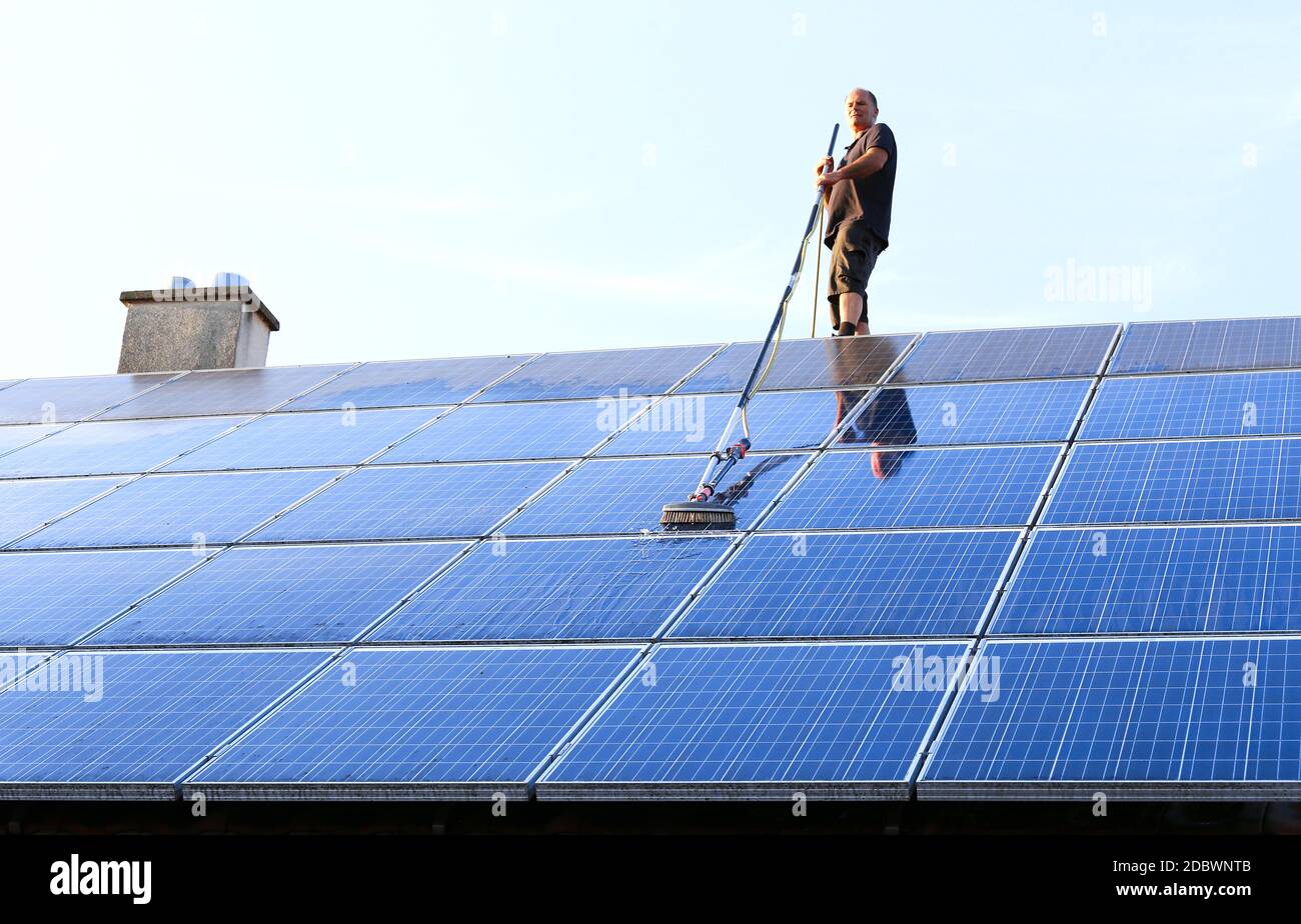 Cleaning solar panels with brush and water Stock Photo Alamy