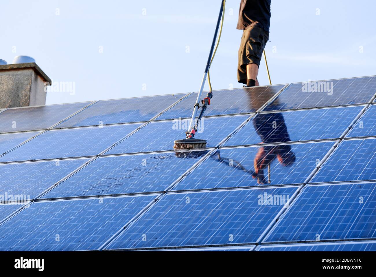 Cleaning solar panels with brush and water Stock Photo Alamy