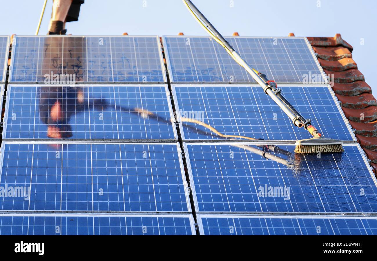 Cleaning solar panels with brush and water Stock Photo Alamy