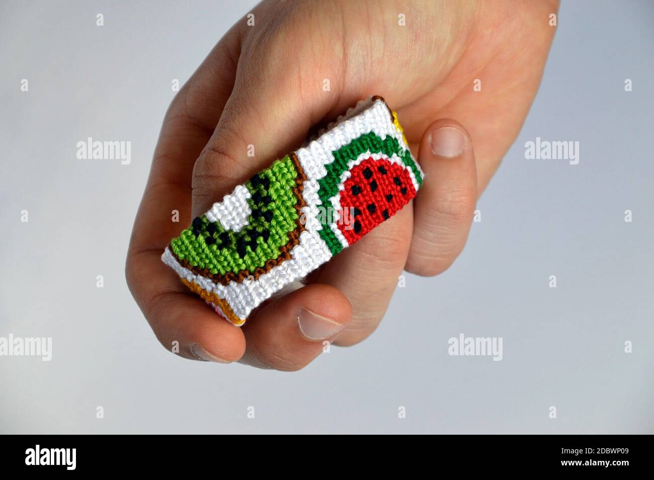 Male hand with woven friendship bracelet handmade of thread with fruit  pattern isolated on white background Stock Photo - Alamy