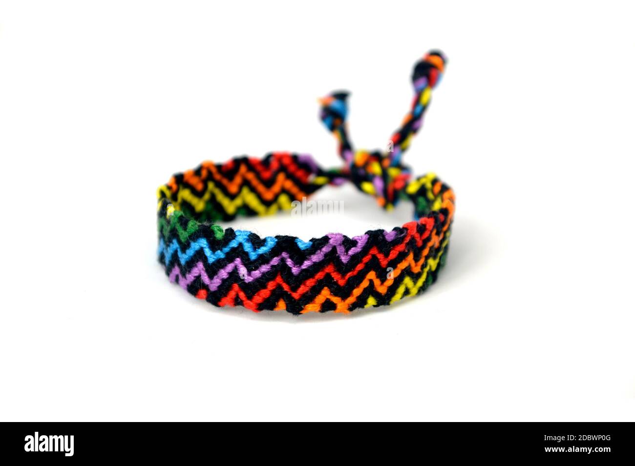 Selective focus of tied woven friendship bracelet with bright colorful ...