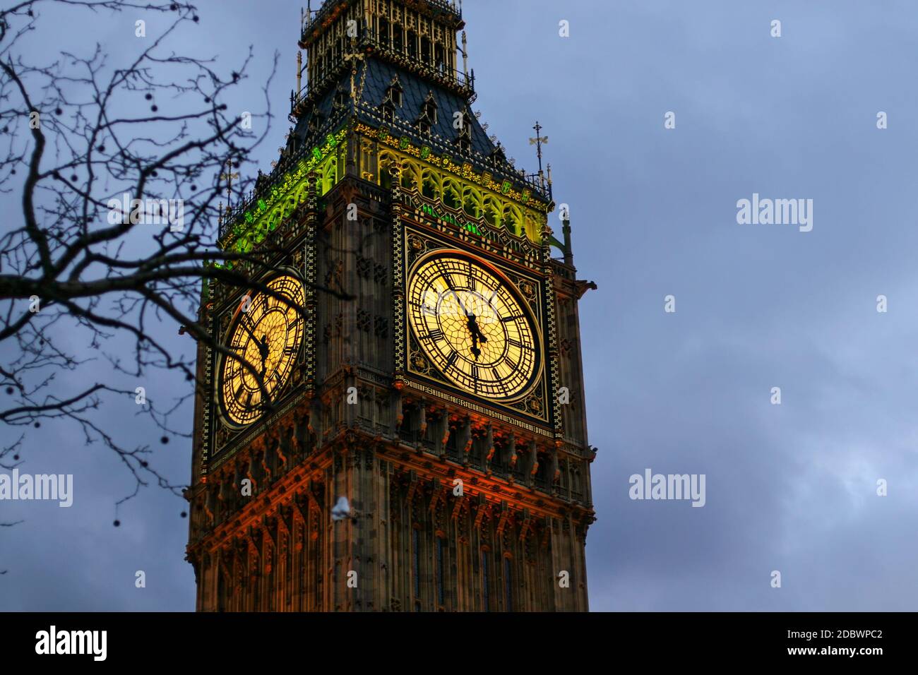Detail of clock on Big Ben in London, United Kingdom illuminated by lights in evening Stock