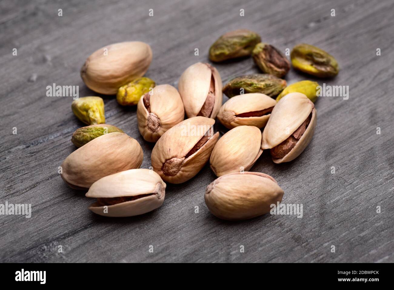 Pile of roasted pistachio nuts (Pistacia vera) in shell and seeds on