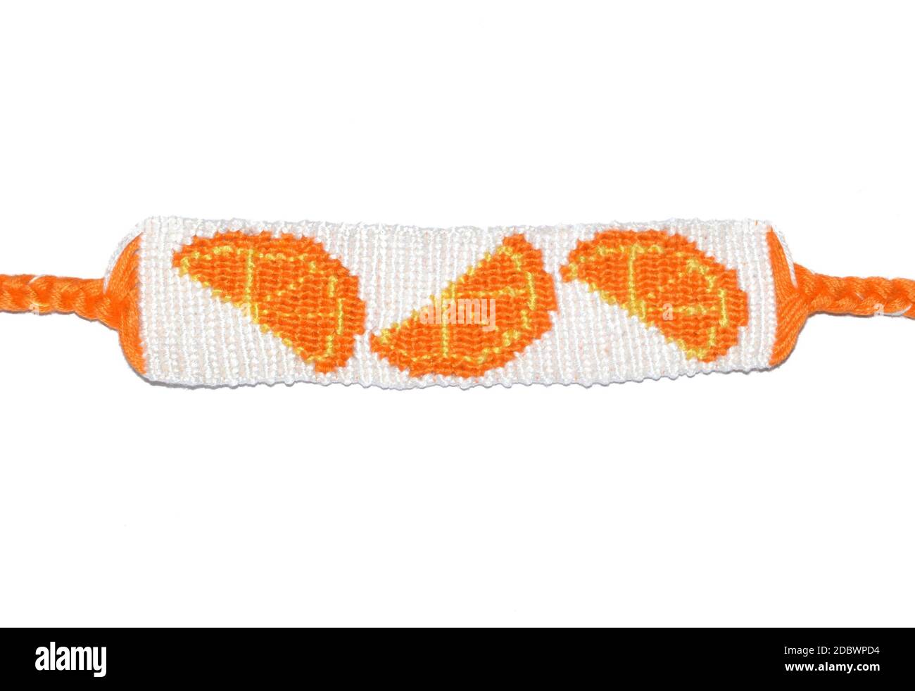 Woven friendship bracelet handmade of thread with orange fruit pattern isolated on white backgroud Stock Photo
