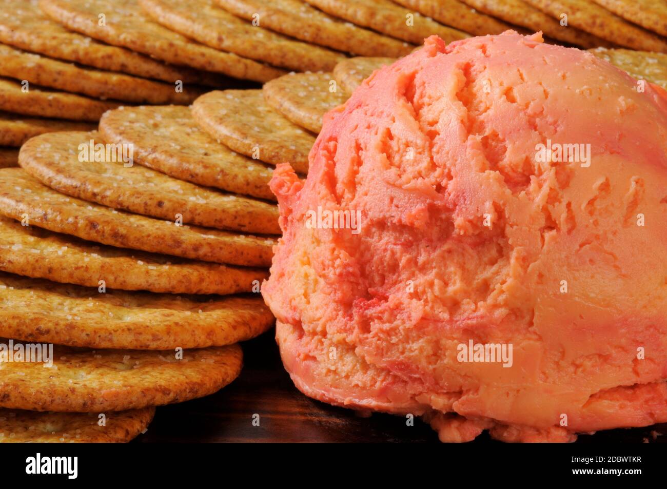 A port wine and cheddar cheese ball with whole wheat crackers Stock
