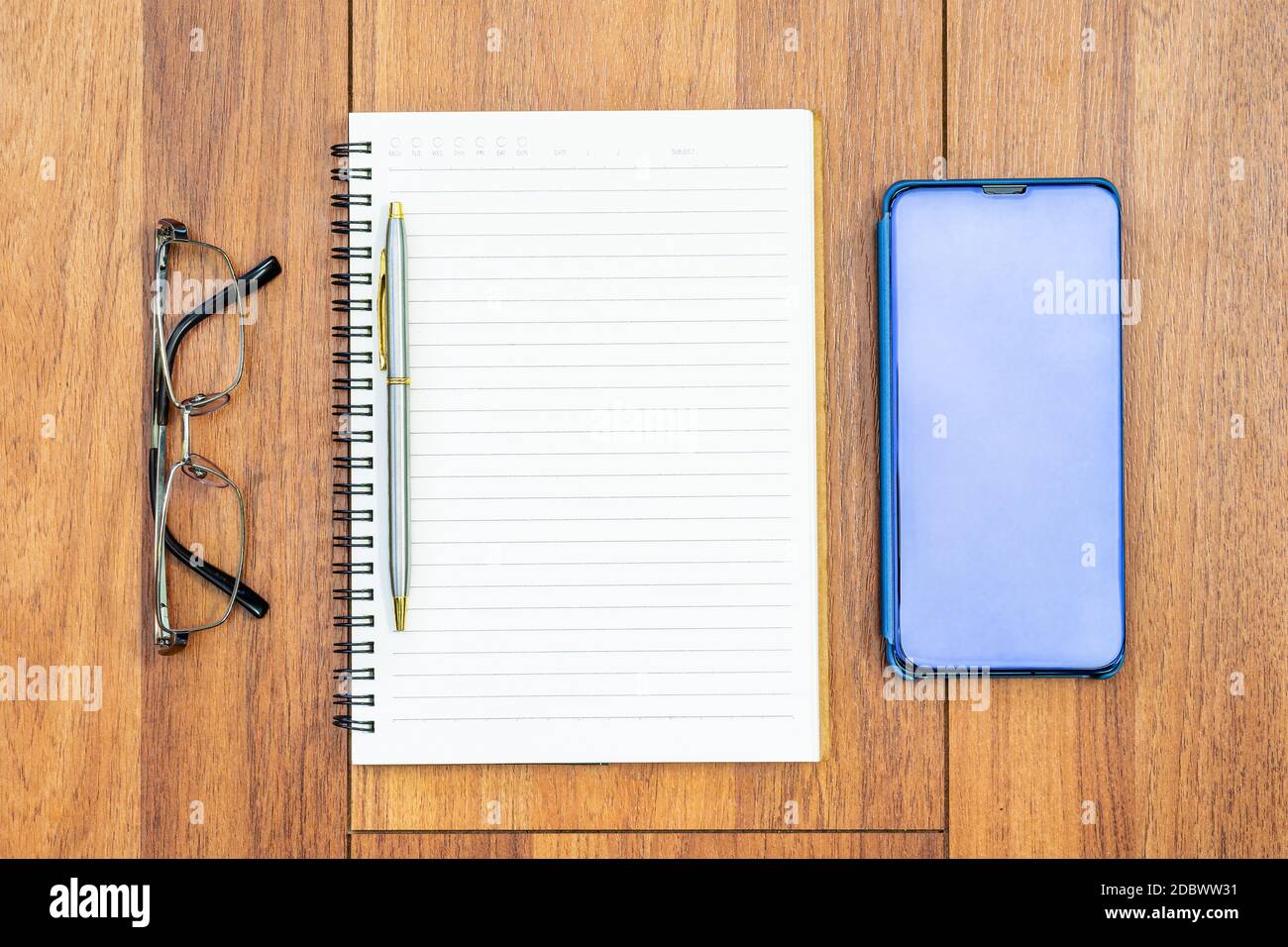 Top view image of open notebook with blank pages and cellphone ,eye ...