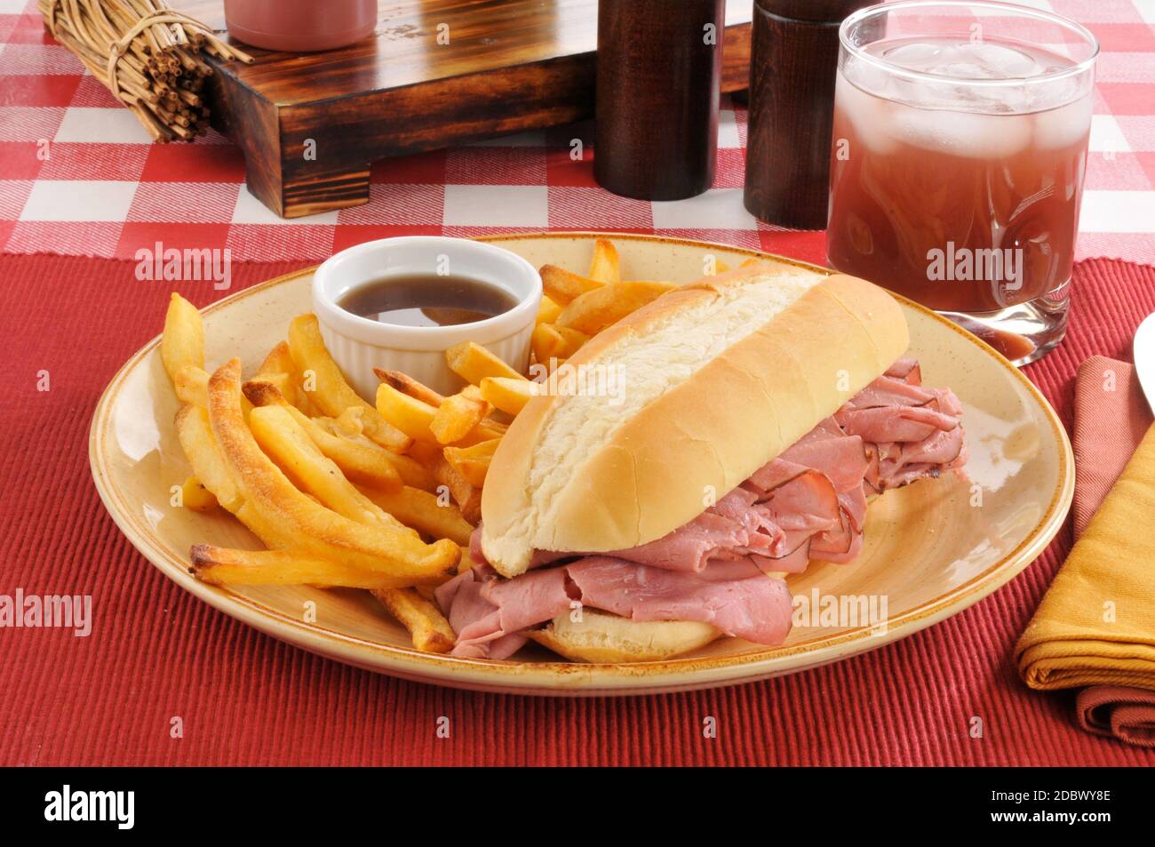 A roast beef sandwich with au jus and fries Stock Photo Alamy