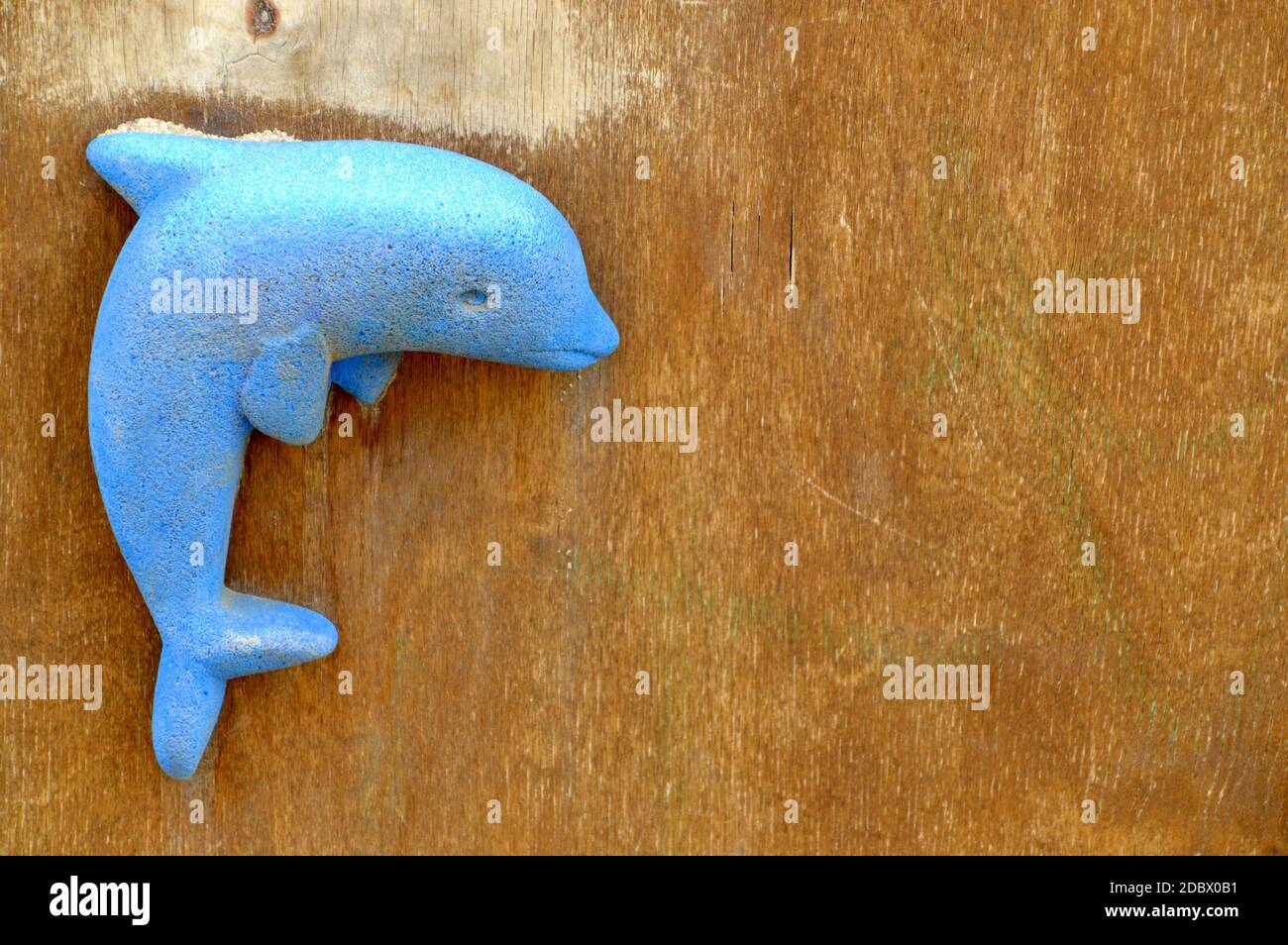 Dolphin toy on wooden background with copy space Stock Photo - Alamy