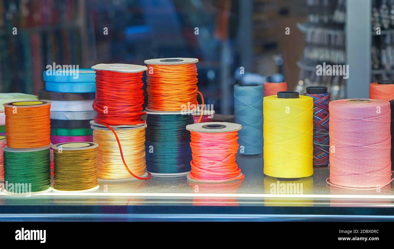 Colorful sewing threads and yarns at spools Stock Photo - Alamy