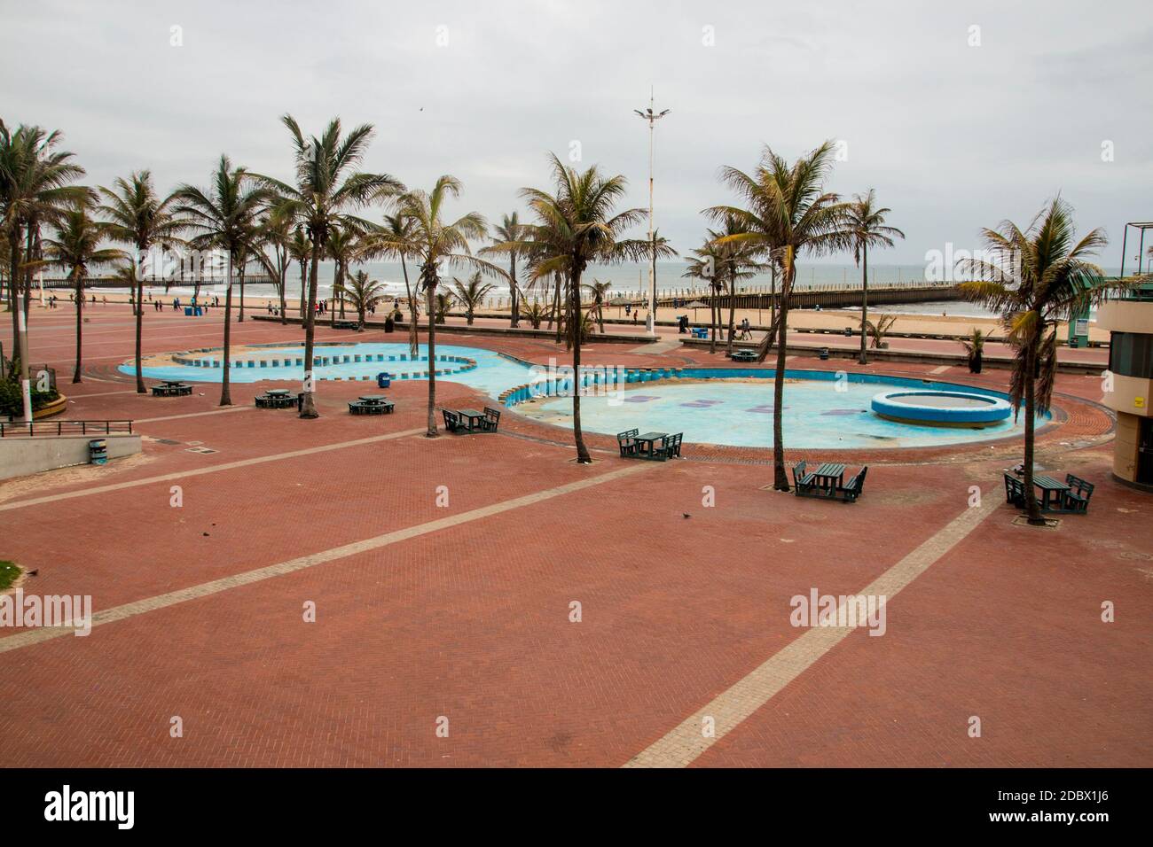 Palm trees line empty childrens' paddling pool in Durban, South Africa