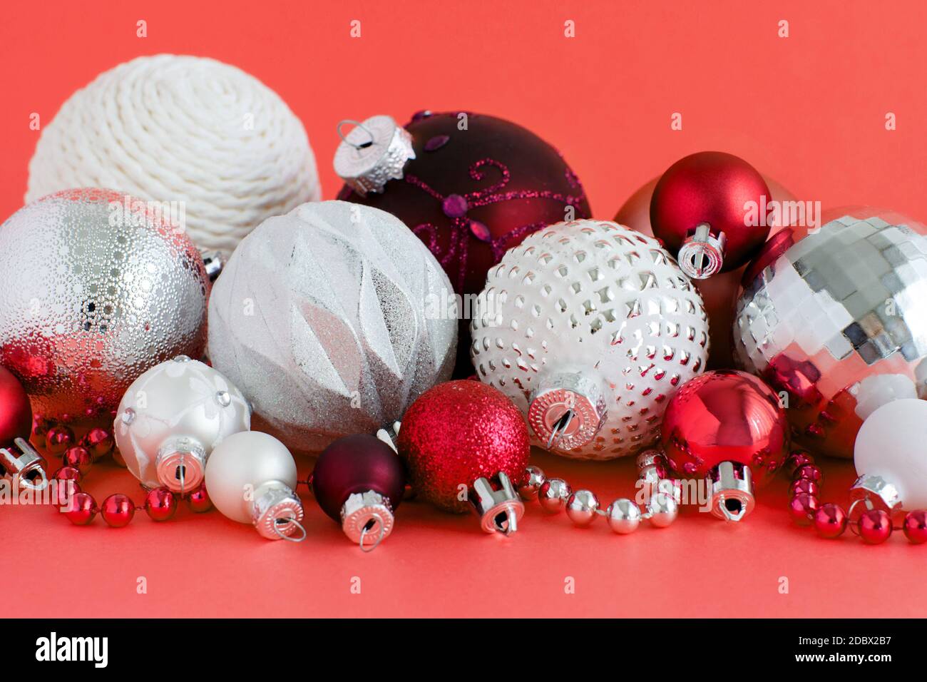 Christmas baubles on a red background close up Stock Photo - Alamy