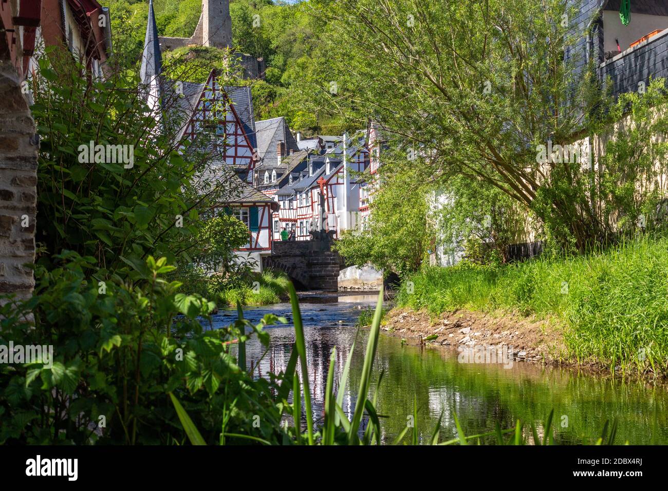The village Monreal with river elz, half-timbered houses and castle Loewenburg in the background Stock Photo