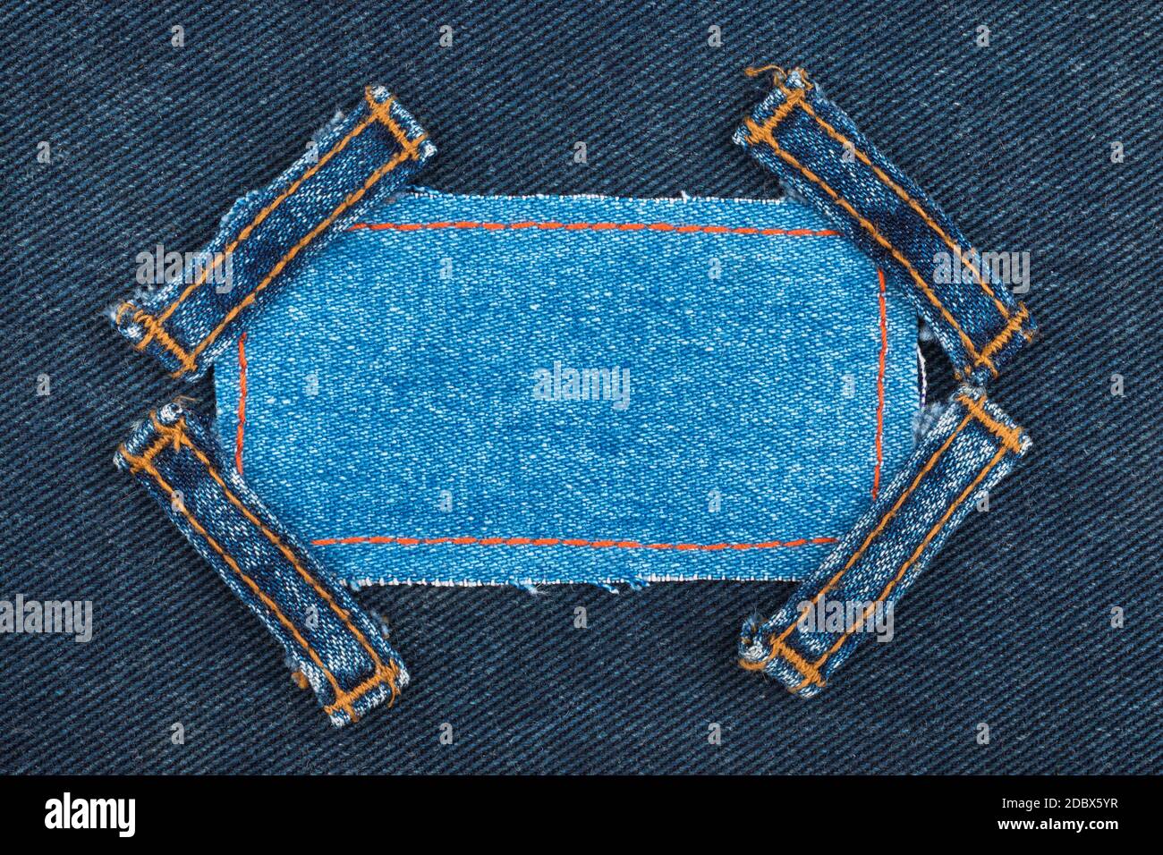 Denim Framelayout Frame made of denim with four straps of jeans, lies on the dark denim ...