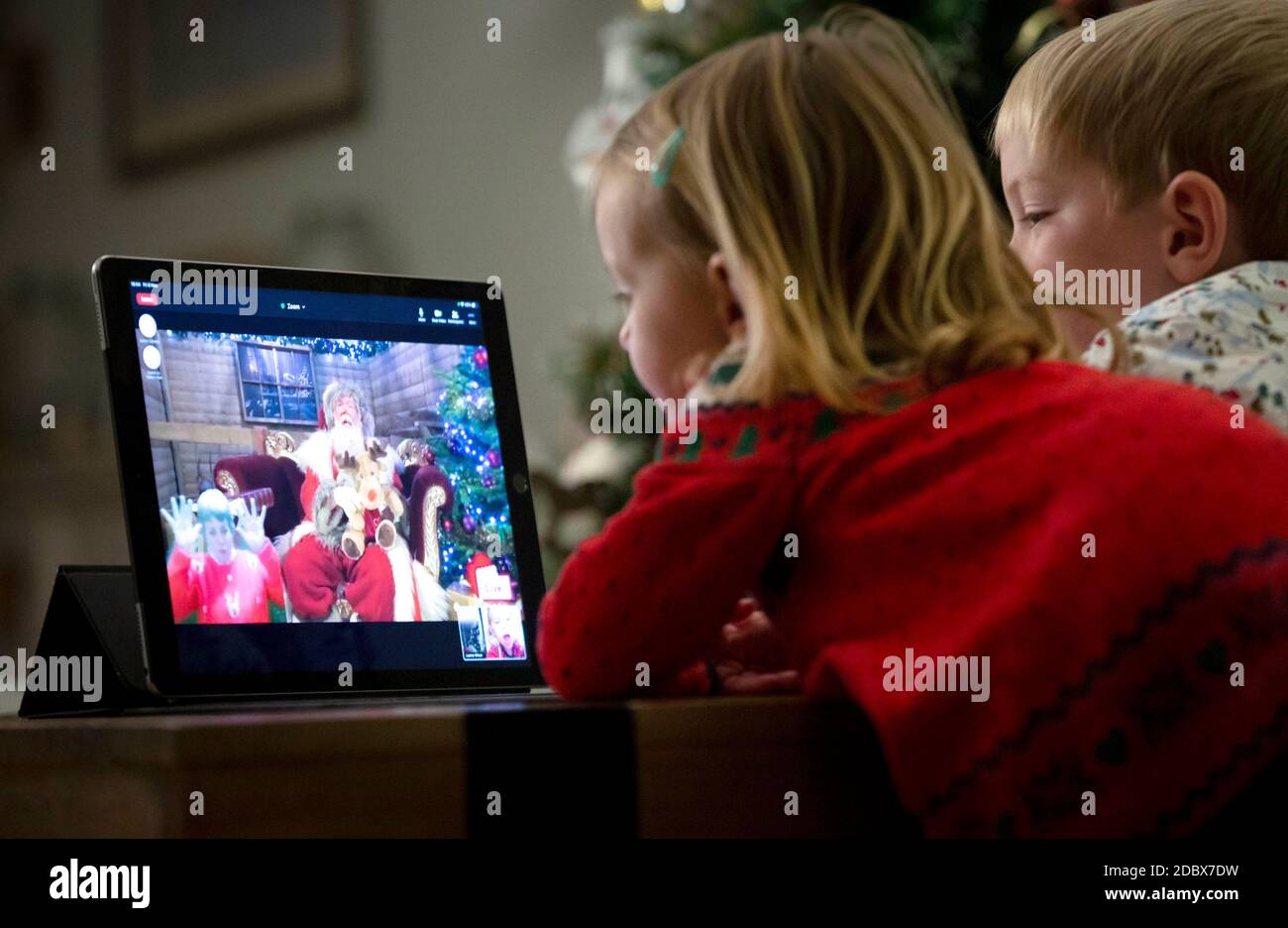 EDITORIAL USE ONLY (Left to right) Amelia, aged 2, and Jacob, aged 4, talk to Santa Claus via live video stream to launch the Virgin Media virtual grotto experience, which will be available for the three weekends leading up to Christmas, as grotto visits this year aren't possible due to Covid-19. Stock Photo