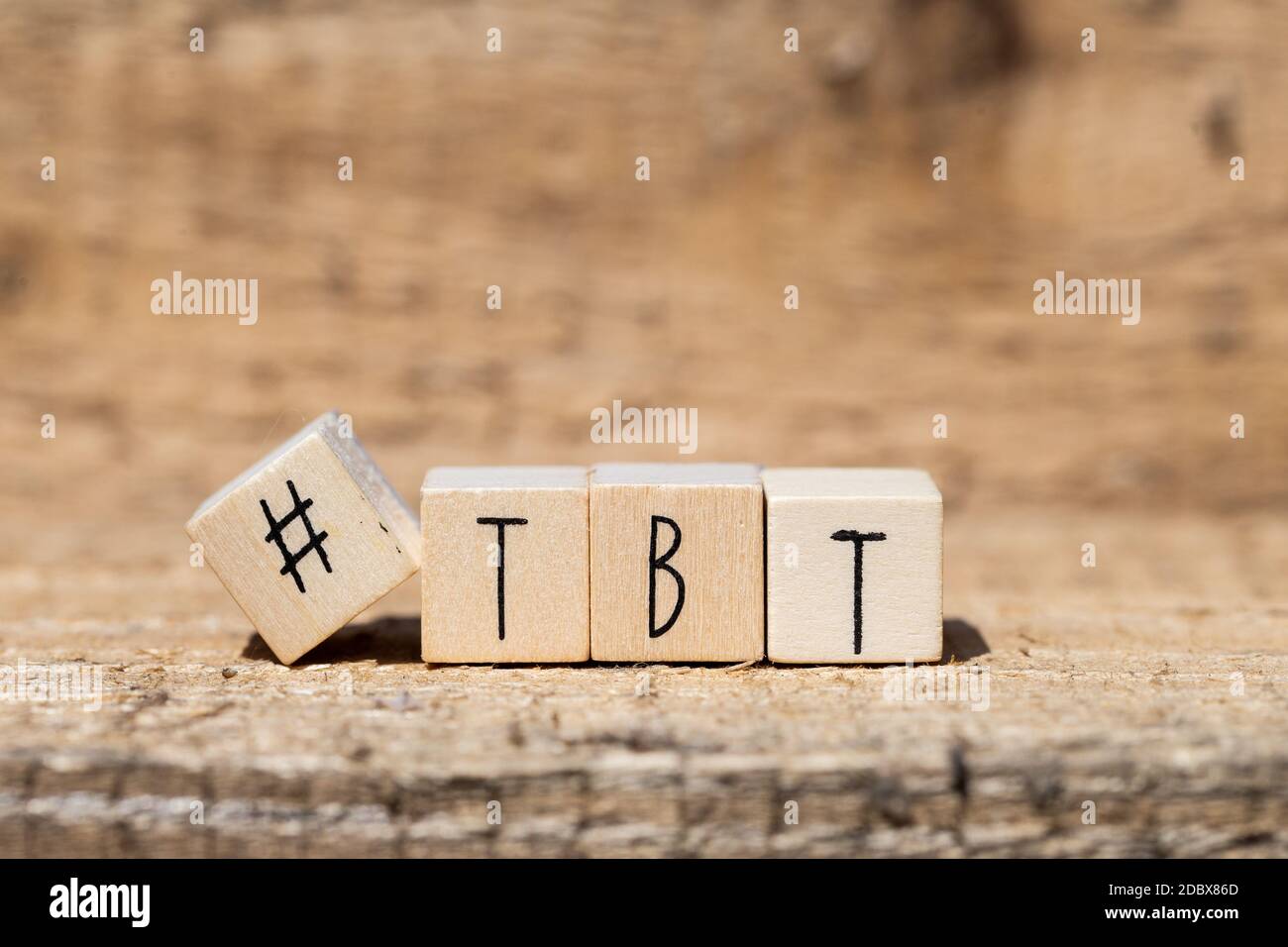 Follow sign made of cubes on a wooden table with Hashtag near white background, socialmedia concept close-up wood background Stock Photo