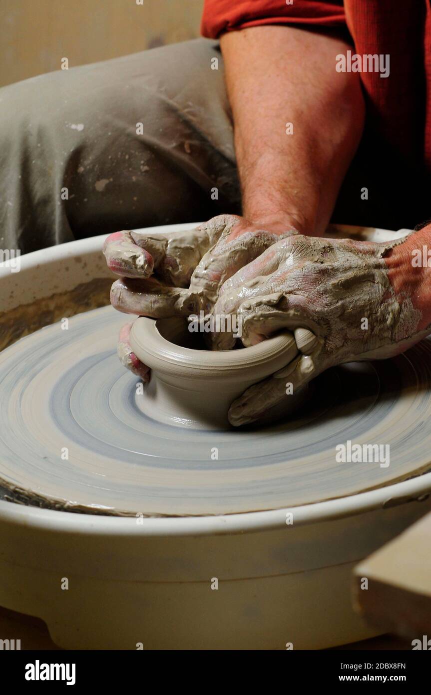man making pottery with his hand on a pottery wheel Stock Photo Alamy